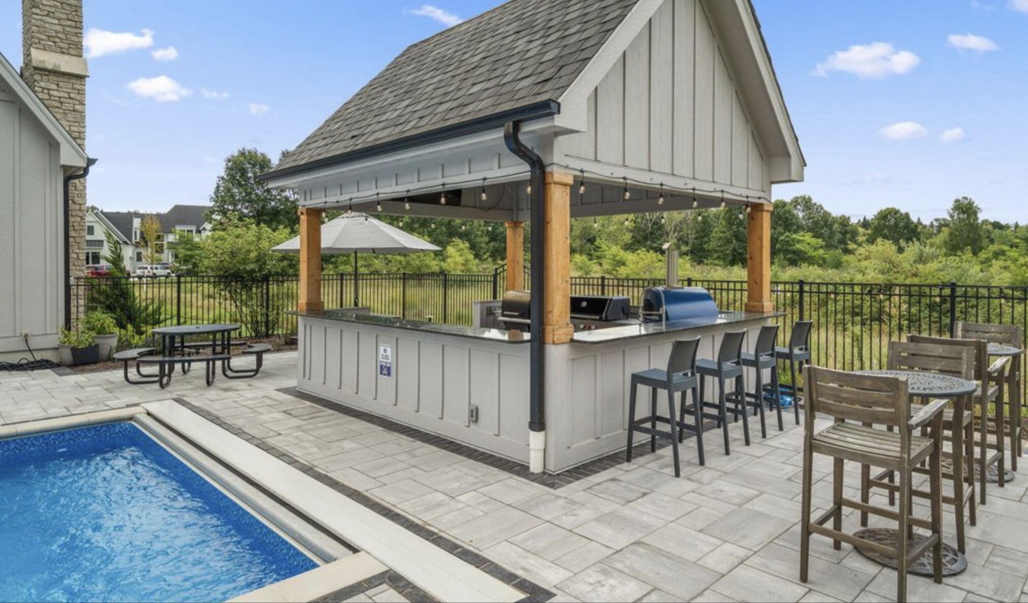 Poolside pavilion with outdoor bar and grill on a dunes-shoreline property